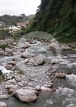 Mountain river Baner flowing through the stones in Himachal Pradesh