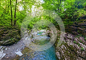 Mountain river with blue water. Wet canyon of the Psakho river