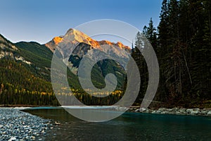 A mountain and river in the Canadian Rockies at sunset