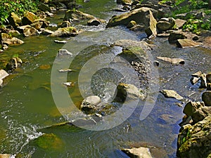 Mountain river with fast stream and big boulders