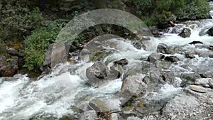 Mountain river. Fast stream moving among rocks.