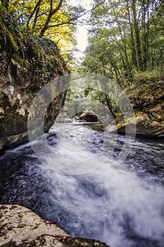 Mountain river flowing between large rocks and trees, rio Lor, Poza das Moulas in Ferreiros de Abajo, Sierra do Courel in Lugo, photo