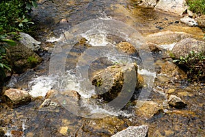 Mountain river flowing over the stones. Wildlife beauty in Malaysia