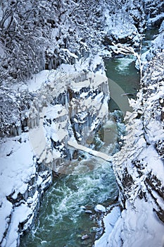 The mountain river in a frozen rocky canyon