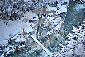 The mountain river in a frozen rocky canyon.