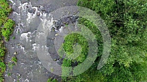 Mountain river and green riverbank from above.