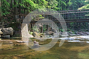 Mountain river Mumlava, Krkonose national park, summer afternoon, footbridge above river, Mumlava waterfall