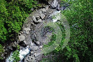 Mountain River rages on rocks on a sunny day