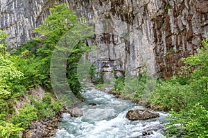 Mountain river at the sheer cliffs