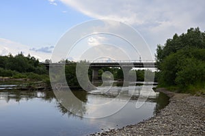 The mountain river with stones ashore