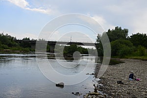 The mountain river with stones ashore