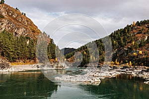 Mountain river surrounded by high rocks in Altai