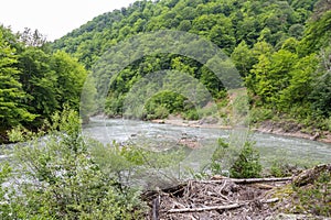 mountain river swift current, whirlpools in the flow of water in a granite canyon photo