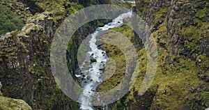 Mountain river and volcanic canyon near Glymur waterfall in Iceland