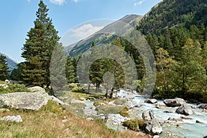 Mountain river water landscape. Alps. The cloudy sky in clear sunny day. Warm summer. Time for pedestrian tourism and family holid