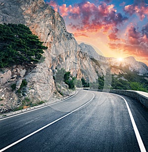 Mountain road and beautiful sky at sunset. Colorful landscape