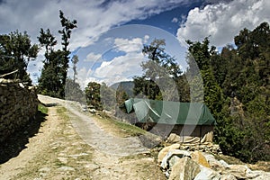 Mountain road bend with blue sky and two luxury tents