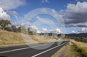 Mountain road with blue sky and clouds