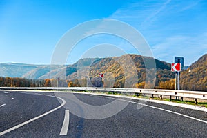 Mountain road bright autumn day with blue sky