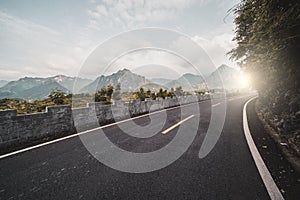 Mountain road, dangerous steep pass with sunlight