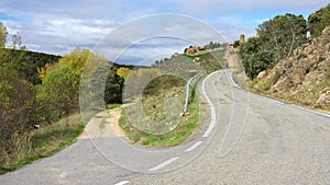 Mountain road leading to the medieval hilltop town of Pedraza, Spain.