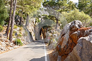 Mountain road road going into a stone tunnel near the village Sa Calobra. Island Majorca, Spain