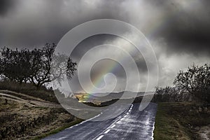 Mountain road with a storm background