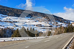 Mountain road in Swiss alps at sunny winter day . Engadine valley , Graubunden; Switzerland photo