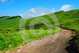 Mountain road to remote green hills