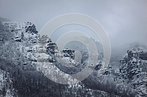 A mountain rock covered with snow