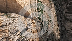 Mountain rock geology formation stone structure speed dive over creek stream canyon aerial view