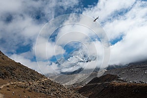 Mountain and route of everest base camp with helicopter on the w