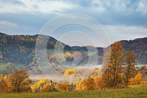 Mountain rural landscape in an autumn foggy morning