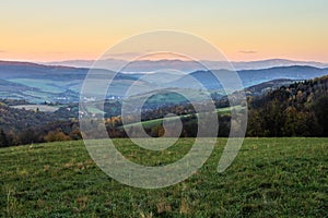 Mountain rural landscape with colorful clear sky at sunset. Late autumn