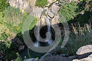 Mountain  Saar Falls with cold and crystal clear water descends from a crevice in the mountains of the Golan Heights in Israel