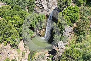 Mountain  Saar Falls with cold and crystal clear water descends from a crevice in the mountains of the Golan Heights in Israel