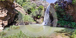 Mountain  Saar Falls with cold and crystal clear water descends from a crevice in the mountains of the Golan Heights in Israel