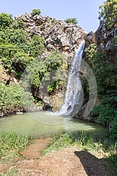 Mountain  Saar Falls with cold and crystal clear water descends from a crevice in the mountains of the Golan Heights in Israel