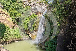 Mountain  Saar Falls with cold and crystal clear water descends from a crevice in the mountains of the Golan Heights in Israel