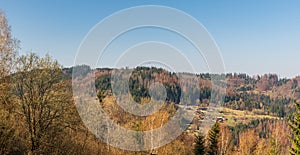 Mountain scenery above Turzovka town in Slovakia with hills, forest devastated by bark beetle and dispersed settlement