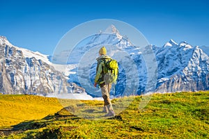 Mountain scenery. Rock climber with a backpack. View of the valley and mountain peaks. Nature.
