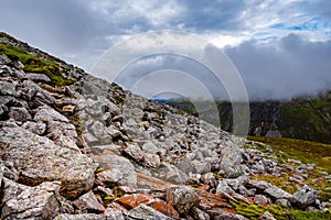 Mountain in the Scottish Highlands, situated about 3 km to the west of Tyndrum. Rocks are on top of mountain hill with low cloud c