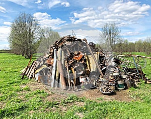 Mountain of scrap metal and garbage in the field. Recycling, sorting