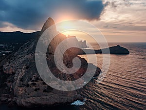 Mountain in sea, large rock at beautiful sunset and seascape nature landscape, aerial panoramic view