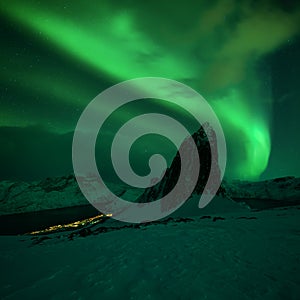 Mountain Segla and sky background with northern lights. Aurora borealis on Senja islands, Norway. Northern lights above mountains.