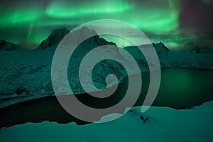 Mountain Segla and sky background with northern lights. Aurora borealis on Senja islands, Norway. Northern lights above mountains.