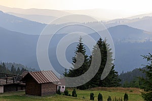 Golden hour sunset light over distant, layered mountain ridges photo