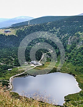 Mountain shelters Samotnia and Strzecha Akademicka over MaÅ‚y Staw pond in Sudetes.