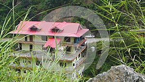 Mountain-side multistory building in Himachal Pradesh, offering homestay and vacation home accommodations