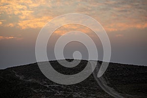 mountain silhouette in the desert at sunset sunrise